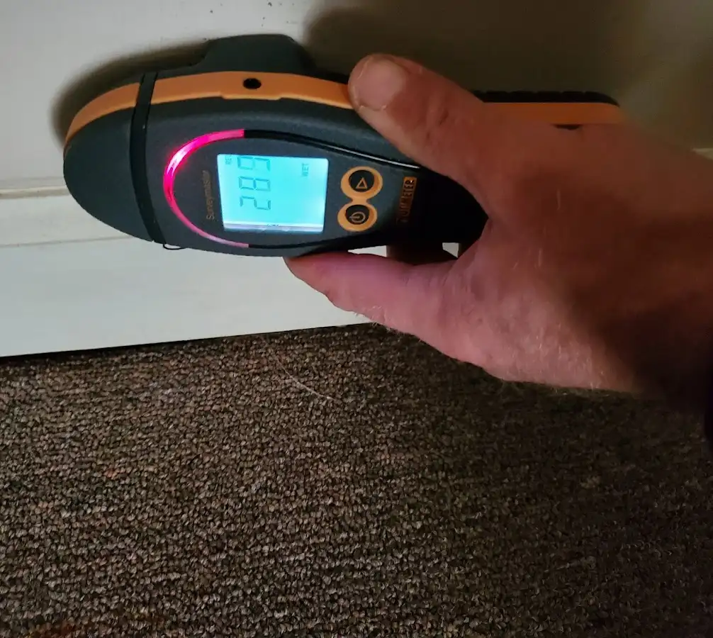 Moisture detection at baseboard during Storm Damage Restoration in Hazlet